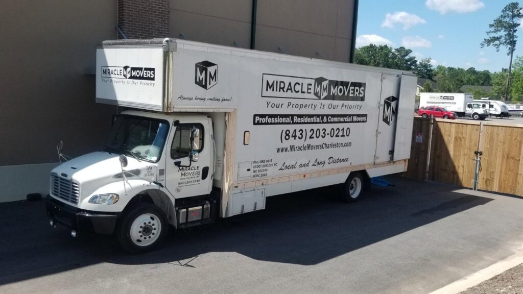A white Miracle Movers of Charleston, SC truck parked in a lot, ready for service in Summerville, SC.