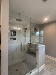 A modern and pristine bathroom with a glass shower enclosure, showcasing the detailed cleaning provided by Cleaning Sisters LLC in Richmond, VA.