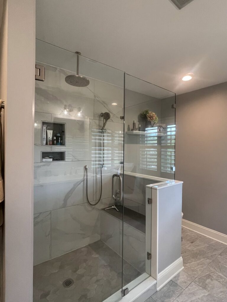 A modern and pristine bathroom with a glass shower enclosure, showcasing the detailed cleaning provided by Cleaning Sisters LLC in Richmond, VA.
