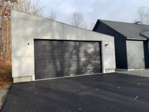A modern black garage door on a contemporary style home installed by J.A. Overhead Door in Westfield, MA.