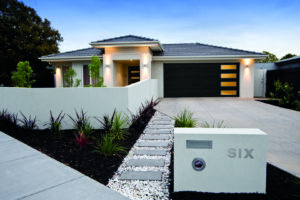 A contemporary house showcasing a sleek black garage door installed by Access Garage Doors of Treasure Valley in Meridian, ID.