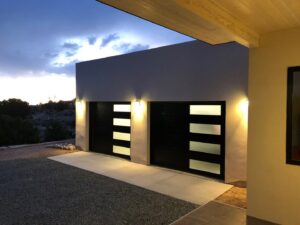 Two modern black garage doors with frosted glass panels installed by Precision Garage Door of Albuquerque and Santa Fe, NM.