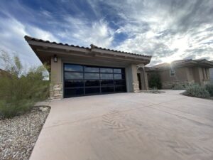 A modern black glass garage door on a home exterior, installed by Legacy ODS Garage Door Services in Las Vegas, NV.