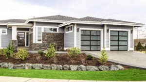 A contemporary house with two sleek black glass garage doors installed by Overhead Door Company of Little Rock in North Little Rock, AR.