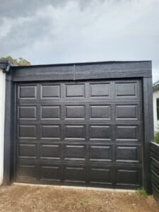 A modern black panel garage door recently installed by Spartan Garage Doors and More in Albuquerque, NM.