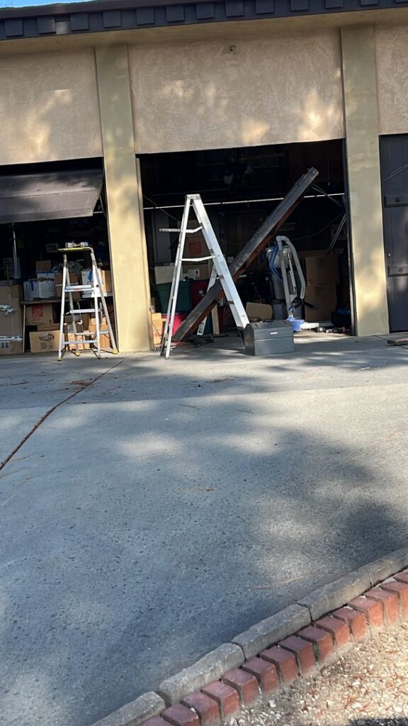 A modern blue garage building with a newly installed white garage door by Summit Garage Door in Overland Park, KS.