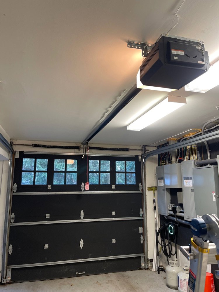 A modern brown garage door with horizontal windows installed by Up & Down Garage Doors New Haven in New Haven, CT