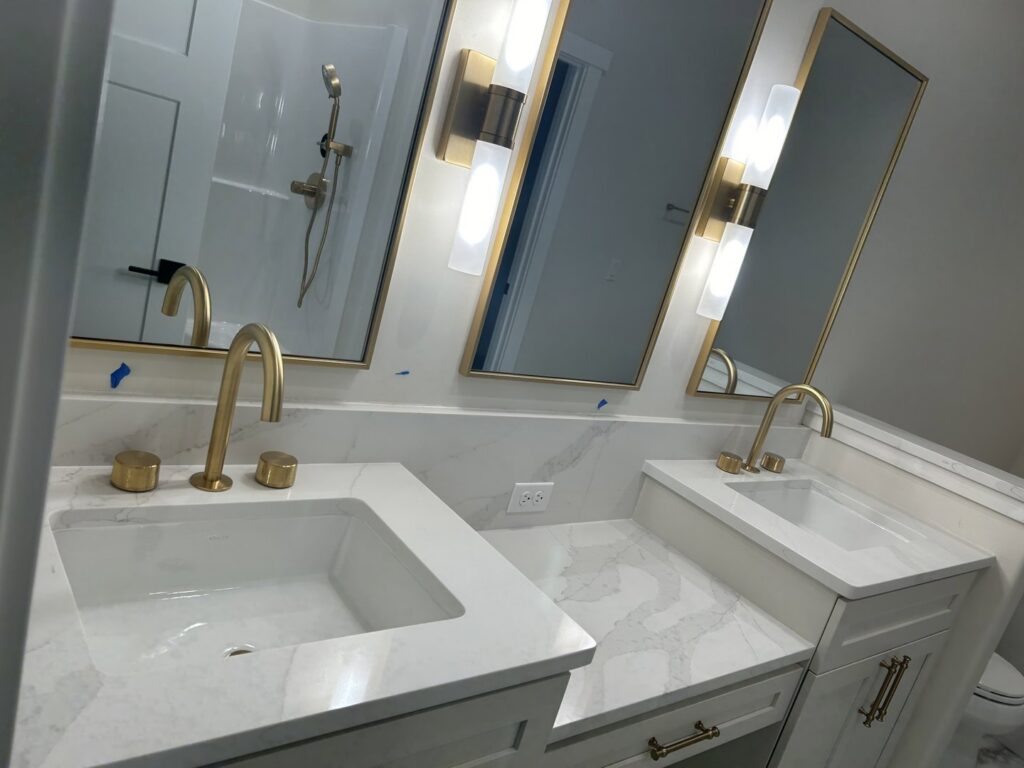 A modern and clean bathroom featuring elegant gold fixtures, cleaned by Martinez Cleaning Services in Kent, WA