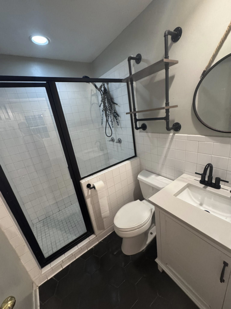 A modern and impeccably clean bathroom with a glass shower and vanity, provided by Pristine Cleaning Services in Thornton, CO.