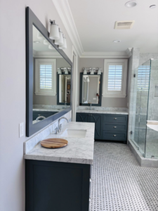 A modern and clean bathroom featuring a vanity, large mirror, and glass shower, cleaned by Clean departure Cleaning service in Reseda, CA.