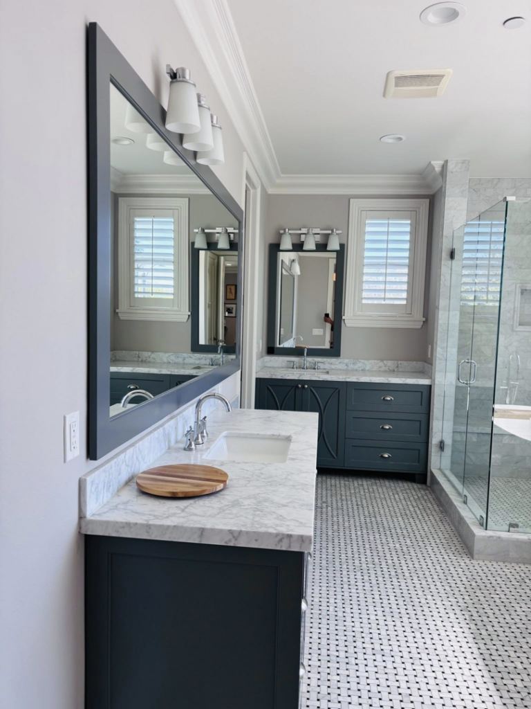A modern and clean bathroom featuring a vanity, large mirror, and glass shower, cleaned by Clean departure Cleaning service in Reseda, CA.