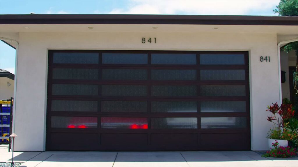 A newly installed modern dark brown garage door with frosted glass panels by Garage Door Medics in Boise, ID.