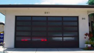 A newly installed modern dark brown garage door with frosted glass panels by Garage Door Medics in Boise, ID.
