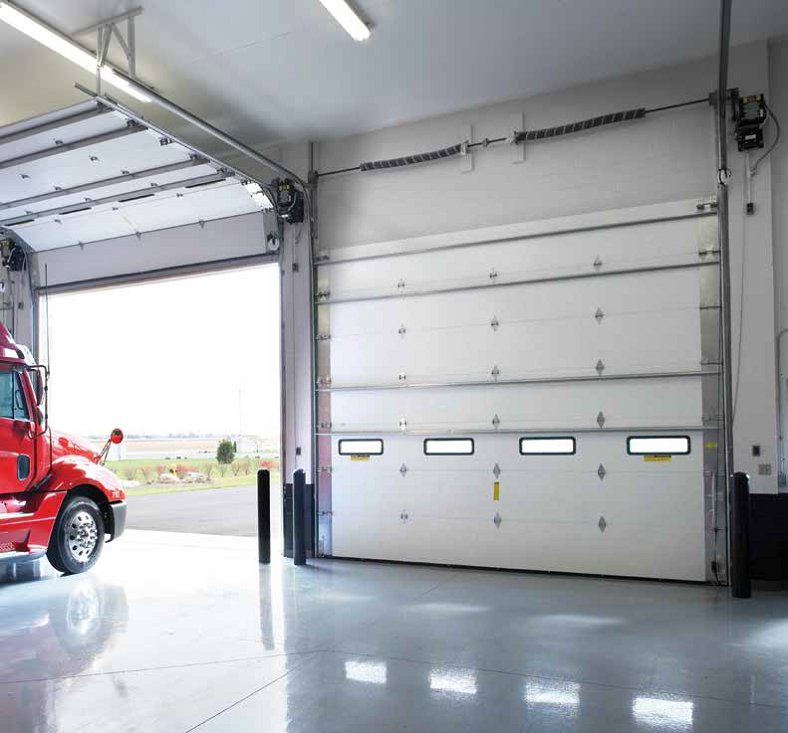 A modern dark gray garage door with horizontal windows installed on a residential home by Wayne Dalton Sales & Service of Albuquerque, NM