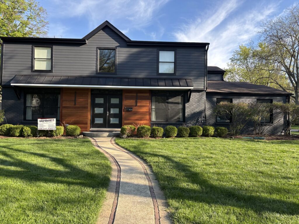 A modern home with dark gray siding and natural wood accents by SmardBuild Siding and Exteriors in Naperville, IL