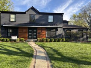 A modern home with dark gray siding and natural wood accents by SmardBuild Siding and Exteriors in Naperville, IL