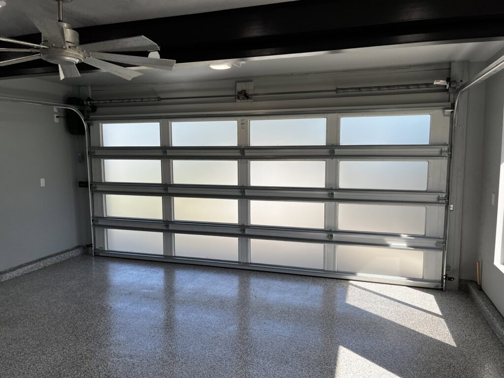 A modern full-view frosted glass garage door from the interior, installed by Over The Top Garage in Albuquerque, NM.