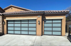 Two modern garage doors with frosted glass panels installed on a house by Apex Garage Doors LLC in Las Vegas, NV