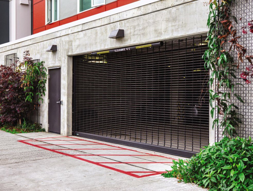 A modern glass and frosted panel garage door installed on a building by Wayne Dalton Sales & Service of Albuquerque, NM