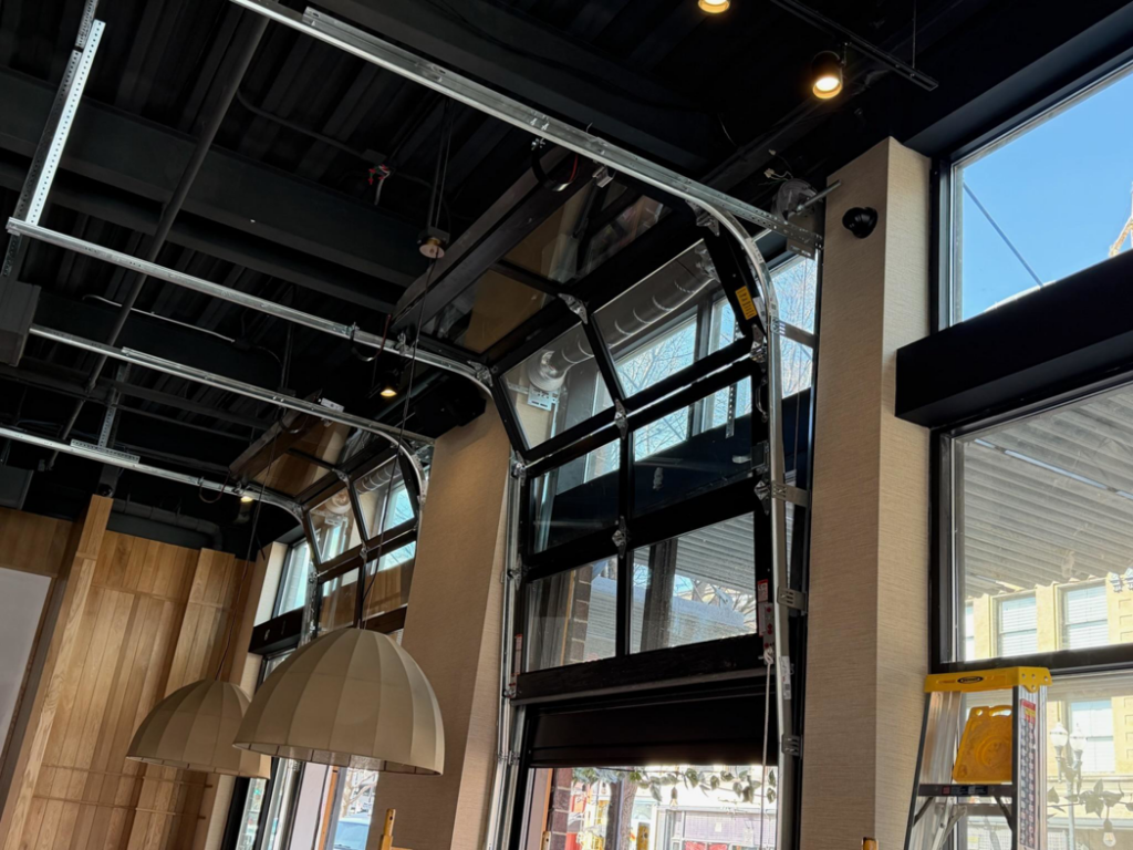 A modern glass garage door system installed by Garage Door Services, Inc. in Omaha, NE.