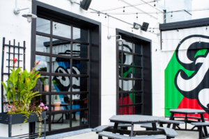 Modern glass garage doors installed on a commercial building by Quality Garage Door in West Fargo, ND