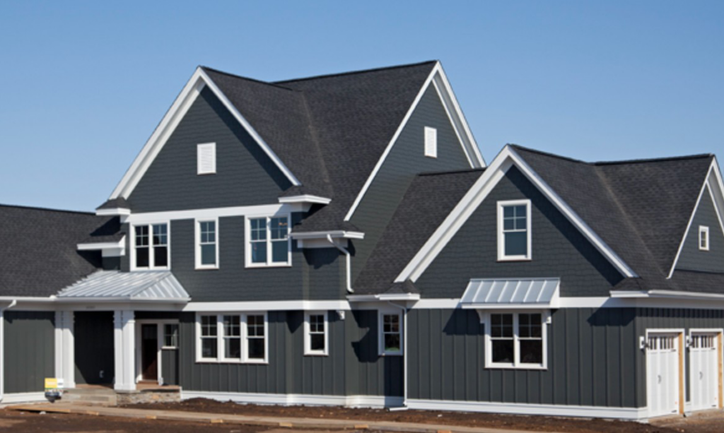 A modern home featuring dark gray siding and white trim, completed by Legend Exteriors & Construction in West Chicago, IL