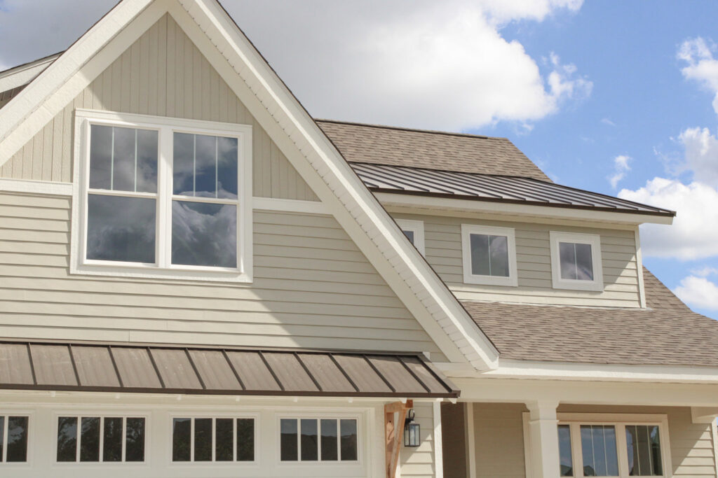 A modern home exterior showcasing light-colored horizontal siding expertly installed by Xtreme Exteriors in Rogers, AR.