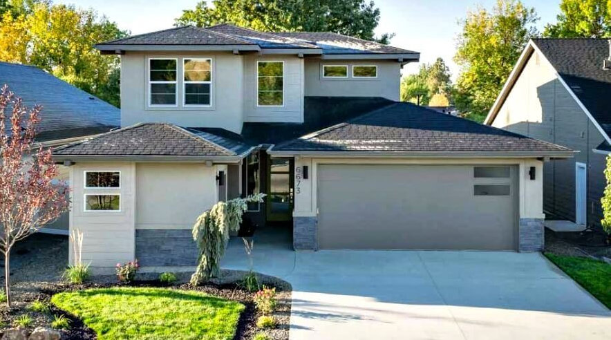 A modern home with a stylish gray garage door, a service provided by Sawtooth Garage Doors in Boise, ID.