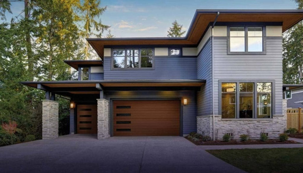 A modern home featuring two stylish brown garage doors installed by Sawtooth Garage Doors in Boise, ID.
