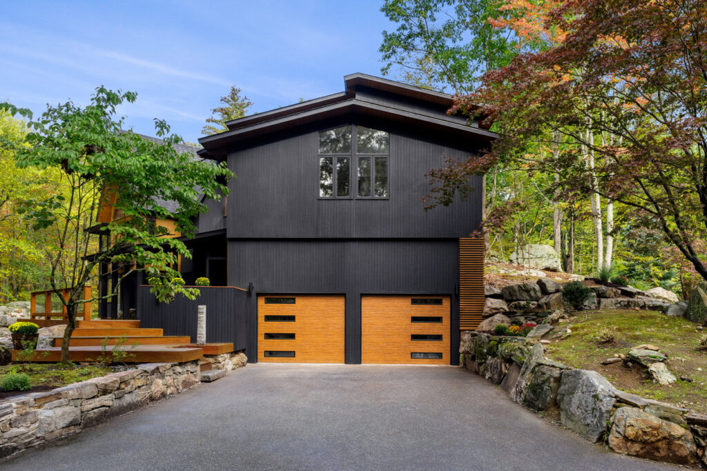 A modern home featuring two stylish wood-look garage doors installed by 775 Overhead Doors in Carson City, NV.
