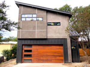 A modern home featuring a stylish wood panel garage door installed by 775 Overhead Doors in Carson City, NV.