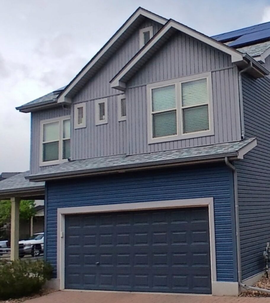 A modern house showcasing blue vertical and horizontal siding installed by Urban Exteriors LLC in Lakewood, CO.