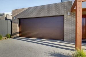 A modern house featuring a brown garage door installed by Up & Down Garage Doors in Bridgeport, CT.