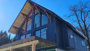 A modern house featuring dark blue siding installed by KC Entities Roofing and Siding in Mechanicville, NY