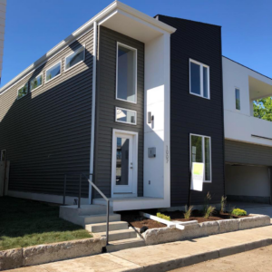 A modern house featuring dark gray siding and white trim, completed by Exterior Building Products in Indianapolis, IN.