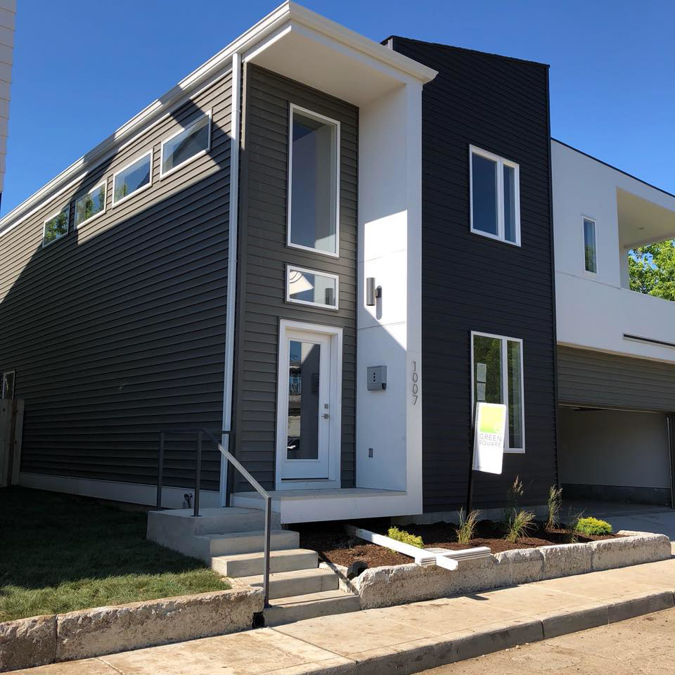 A modern house featuring dark gray siding and white trim, completed by Exterior Building Products in Indianapolis, IN.