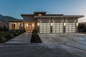 A modern house featuring two stylish glass panel garage doors installed by Windsor Door Sales Inc. in Ogden, UT.