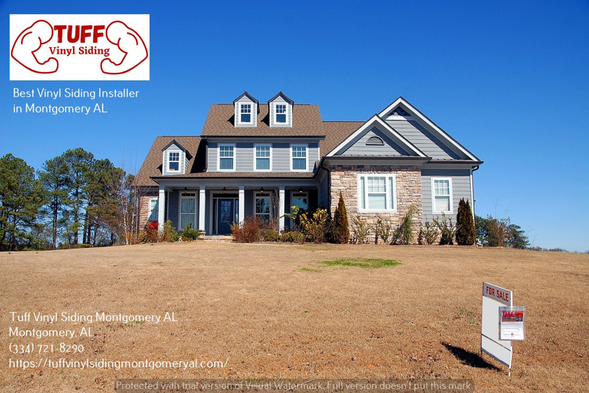 A modern residential house featuring gray vinyl siding and stone accents, installed by Tuff Vinyl Siding Montgomery Al in Montgomery, AL.