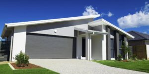 A modern house featuring a grey garage door installed by Pioneer Overhead Door, Inc in Las Vegas, NV.