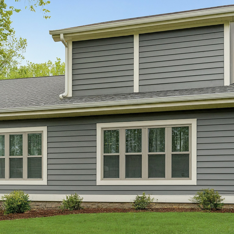 A modern house featuring grey horizontal siding and white trim, installed by Jonesboro Siding, Window & Door in Jonesboro, AR.