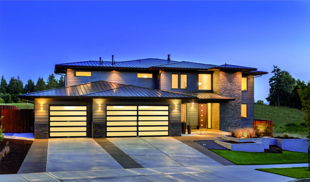 A modern house featuring multiple stylish garage doors installed by Access Garage Doors of Treasure Valley in Meridian, ID.