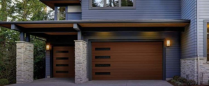 A modern house featuring two brown garage doors with horizontal windows by Advance Garage Door, Inc. in Fargo, ND.