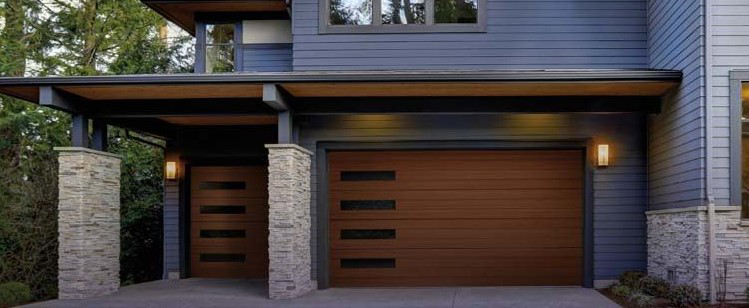 A modern house featuring two brown garage doors with horizontal windows by Advance Garage Door, Inc. in Fargo, ND.