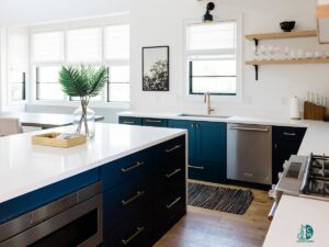 A modern and pristine kitchen with dark blue cabinets and white countertops, showcasing the excellent cleaning services of CleanCo Works in Scottsdale, AZ.