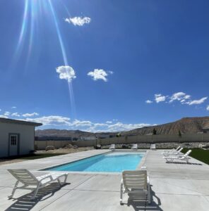 A modern residential swimming pool with a spacious deck and lounge chairs, built by Battle Born Pool & Spa in Sparks, NV.