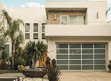 A modern white-framed glass garage door on a contemporary home, installed by K & B Door Co. in Las Vegas, NV