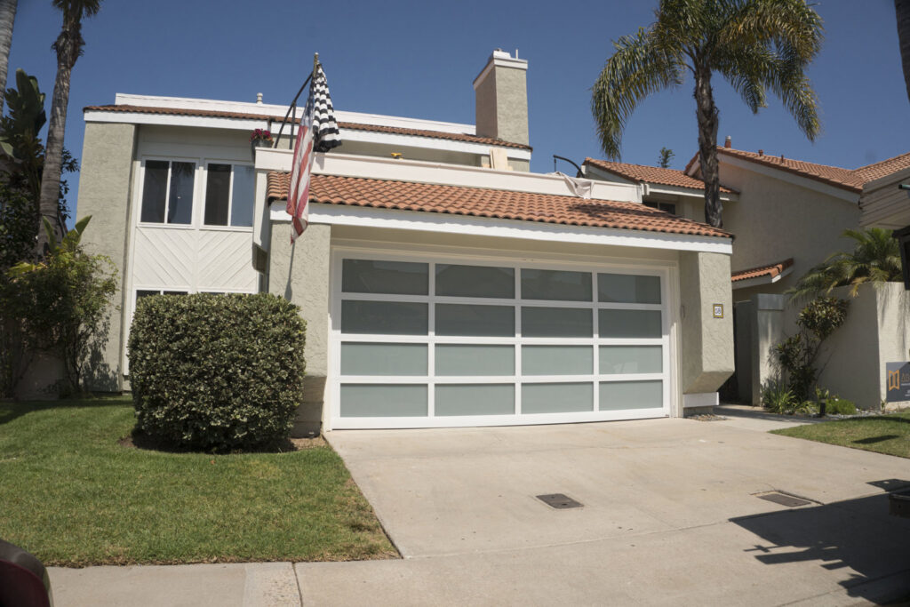 A newly installed modern white garage door with frosted glass panels by Garage Door Medics in Boise, ID.