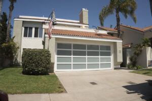 A newly installed modern white garage door with frosted glass panels by Garage Door Medics in Boise, ID.