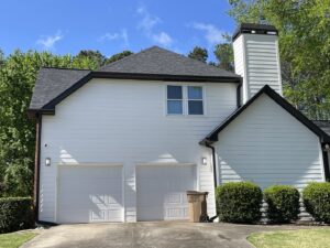 A modern house featuring crisp white siding and black trim installed by HP Exteriors in Woodstock, GA