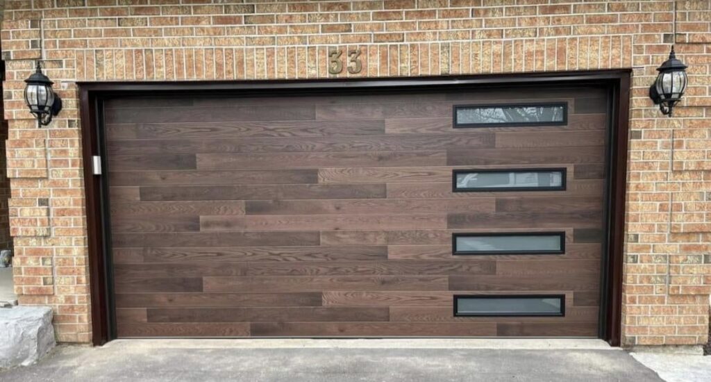A modern wood-look garage door with horizontal windows installed by Delaware Express Garage Door Service in Wilmington, DE